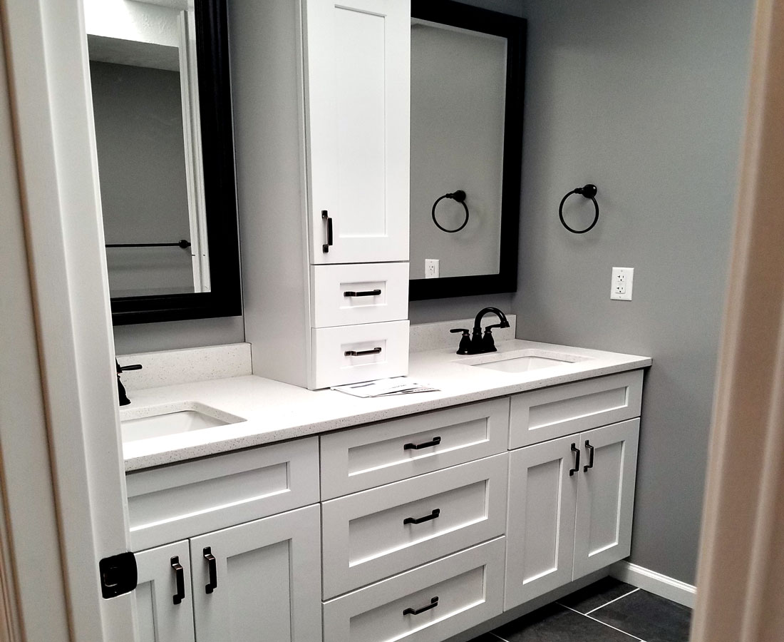 Modern bathroom with two mirrors and stylish black-and-white details.